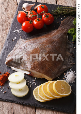 raw flounder with ingredients on a slate board raw flounder with ingredients on a slate board 20180353
