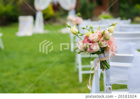 White chair with a bunch of flowers White chair with a bunch of flowers 20181024