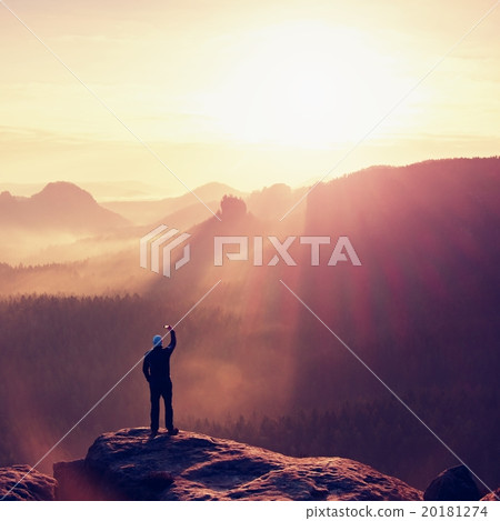 Hiker tak photo by smartphone on mountain cliff Hiker tak photo by smartphone on mountain cliff 20181274