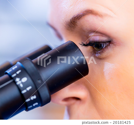 Scientist using a microscope in a laboratory Scientist using a microscope in a laboratory 20181425