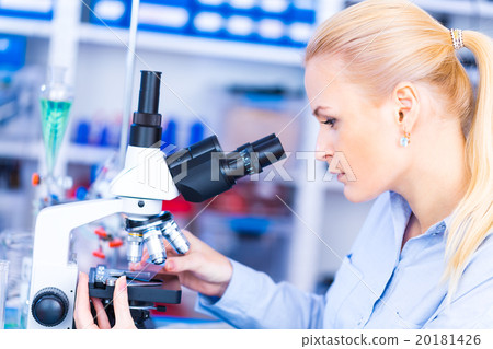 Scientist using a microscope in a laboratory Scientist using a microscope in a laboratory 20181426