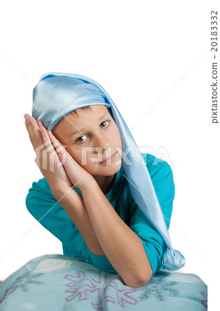 Boy in pajamas and sleeping hat  isolated on white 20183332