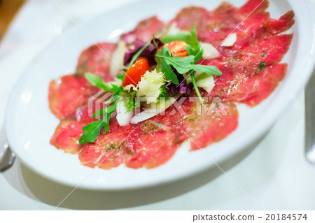 Thin slices of meat carpaccio in white plate 20184574