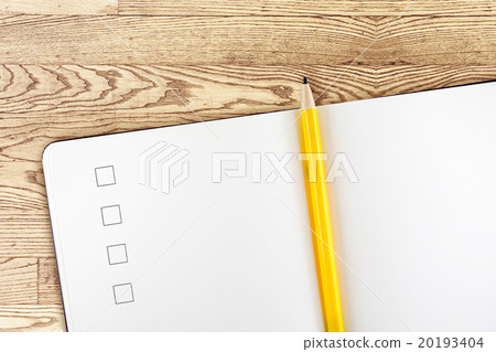 Open notebook and yellow pencil on wooden table 20193404
