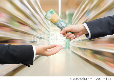 Hands of businessman passing AUD banknote. Hands of businessman passing AUD banknote. 20194175