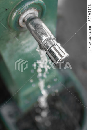 Old standpipe with a water jet. Old standpipe with a water jet. 20195598