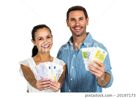 Confident couple holding money Confident couple holding money 20197173