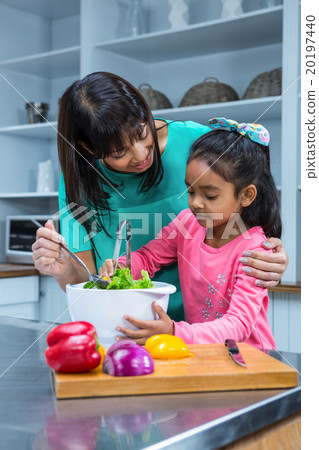 Smiling mother washing salad with her daughter Smiling mother washing salad with her daughter 20197440