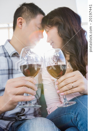 Low angle view of couple holding wineglasses Low angle view of couple holding wineglasses 20197441