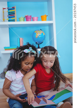 Cute girls holding a book 20197453