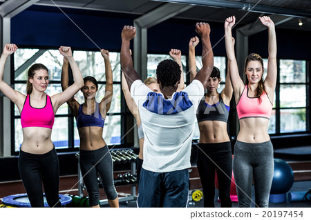 Fit smiling group doing exercise 20197454