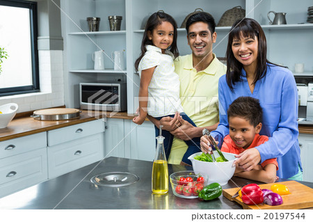Happy family preparing salad in the kitchen 20197544