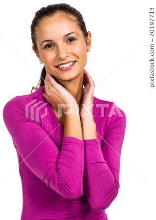 Smiling woman with hands on neck looking at the camera 20197713
