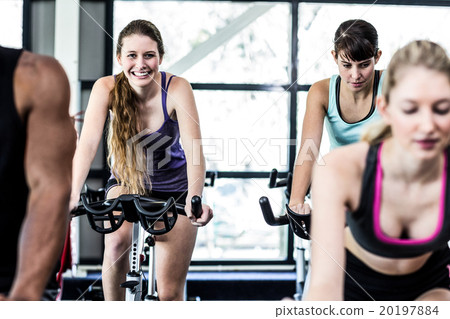 Fit women working out at spinning class Fit women working out at spinning class 20197884