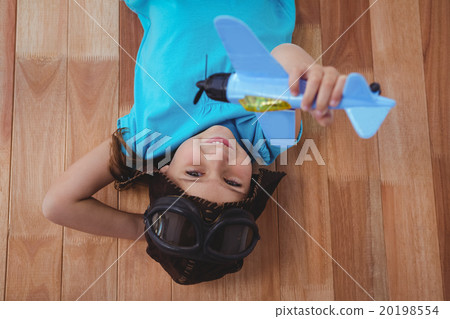 Smiling girl playing with toy airplane Smiling girl playing with toy airplane 20198554