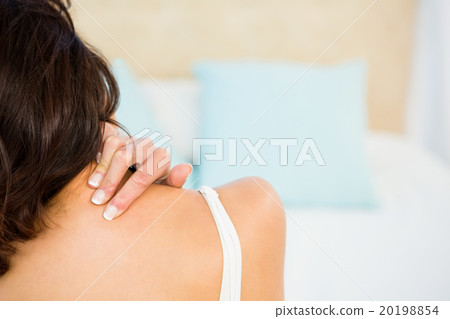Rear view of a woman with neck pain Rear view of a woman with neck pain 20198854