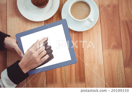 Hipster businesswoman using her tablet Hipster businesswoman using her tablet 20199150