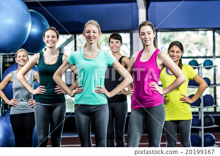 Fit smiling group with hands on hips 20199167