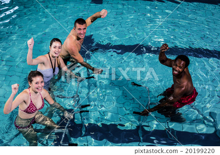 Fitness class doing aqua aerobics on exercise bikes 20199220