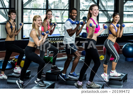 Fit smiling group doing exercise Fit smiling group doing exercise 20199472