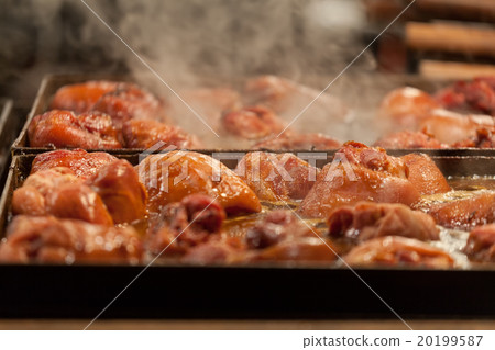 Meat is fried on a big frying pan at street fair Meat is fried on a big frying pan at street fair 20199587