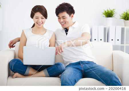 asian Couple on sofa with laptop computer 20200416