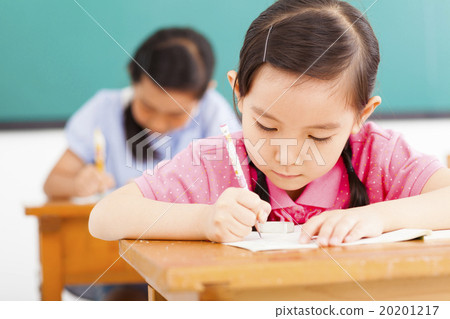 Stock Photo: children in classroom with pen in hand