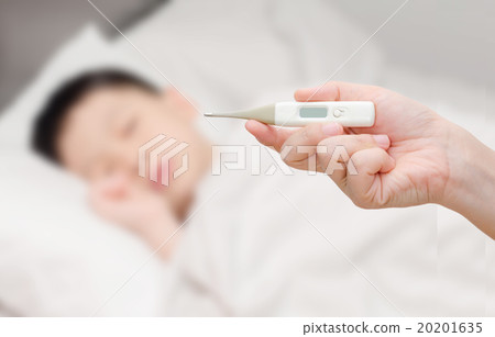 Mother holding thermometer and sick boy in bed 20201635