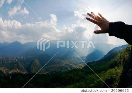 Touch to the sun. Hand touching the sky with ray 20206655
