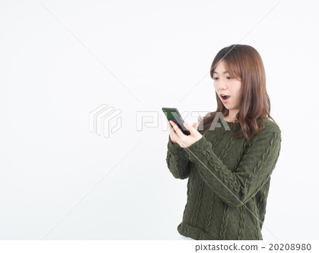 A woman surprised to see the screen of the smartphone A woman surprised to see the screen of the smartphone 20208980