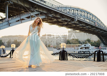Young girl at river bank in the city 20217808