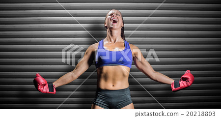 Composite image of winning fighter with arms outstretched 20218803