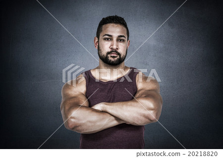 Composite image of muscular man looking at camera Composite image of muscular man looking at camera 20218820