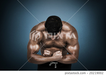 Composite image of muscular man flexing for camera Composite image of muscular man flexing for camera 20219002