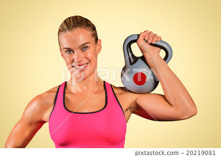 Composite image of muscular woman lifting heavy kettlebell 20219081