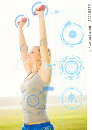 Composite image of smiling sporty blonde lifting dumbbells Composite image of smiling sporty blonde lifting dumbbells 20219479