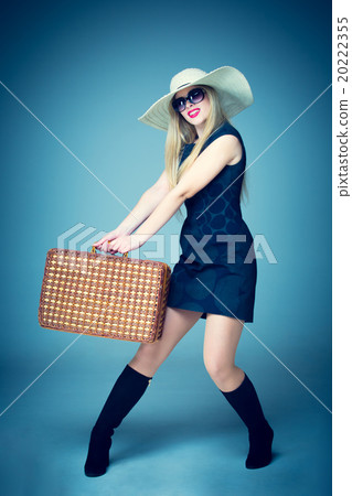 The traveler woman standing with retro suitcase The traveler woman standing with retro suitcase 20222355