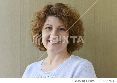 Portrait of middle-aged woman with curly hair Portrait of middle-aged woman with curly hair 20222705