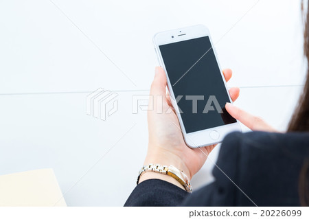 Women's hands touching mobile in office Copy space Smart phone Smartphone Mobile phone White background 20226099