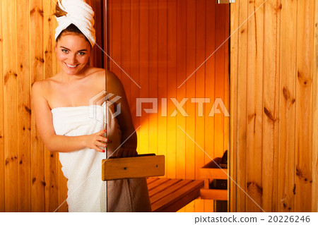 woman relaxing in wooden sauna room woman relaxing in wooden sauna room 20226246
