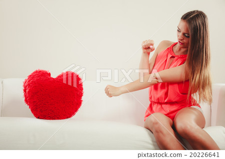 Sad woman with heart shape pillow. Valentines day. 20226641