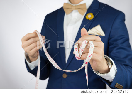 man in blue suit bowtie, brooch 20252562