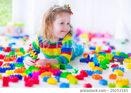 Little girl playing with colorful toy blocks Little girl playing with colorful toy blocks 20253183