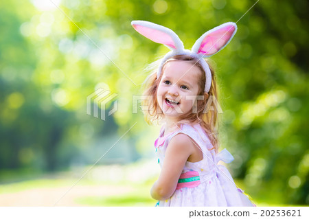 Stock Photo: Little girl with white board for Easter greetings