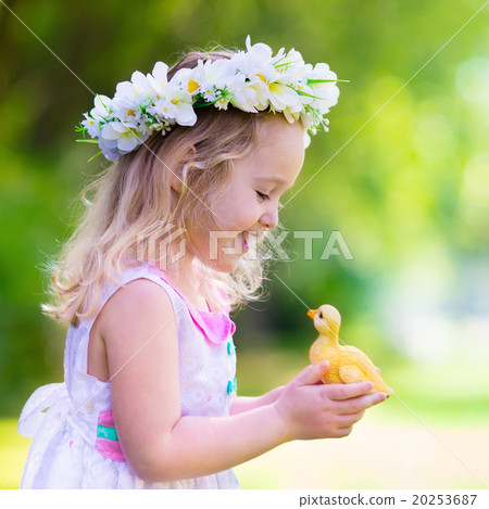 Little girl playing with a toy duck 20253687