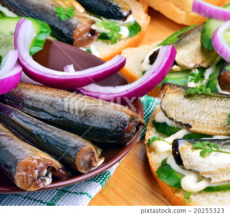 Sprats sandwiches, appetizer, vegetables on paper 20255323