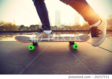 skateboarder skateboarding at sunrise city 20257531