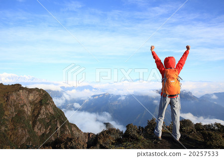 cheering young woman hiker open arms on mountain peak cheering young woman hiker open arms on mountain peak 20257533
