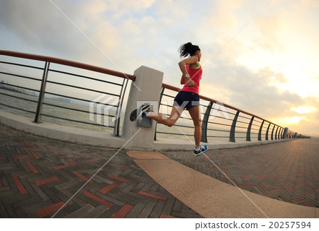 Runner athlete running at seaside. woman fitness silhouette sunrise jogging workout wellness concept. 20257594