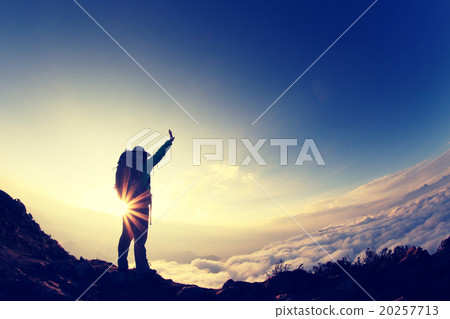 silhouette of backpacker hiking on sunset mountain peak silhouette of backpacker hiking on sunset mountain peak 20257713